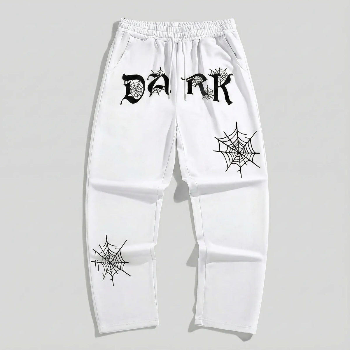 White streetwear sweatpants with black 'DARK' lettering and spiderweb graphic prints