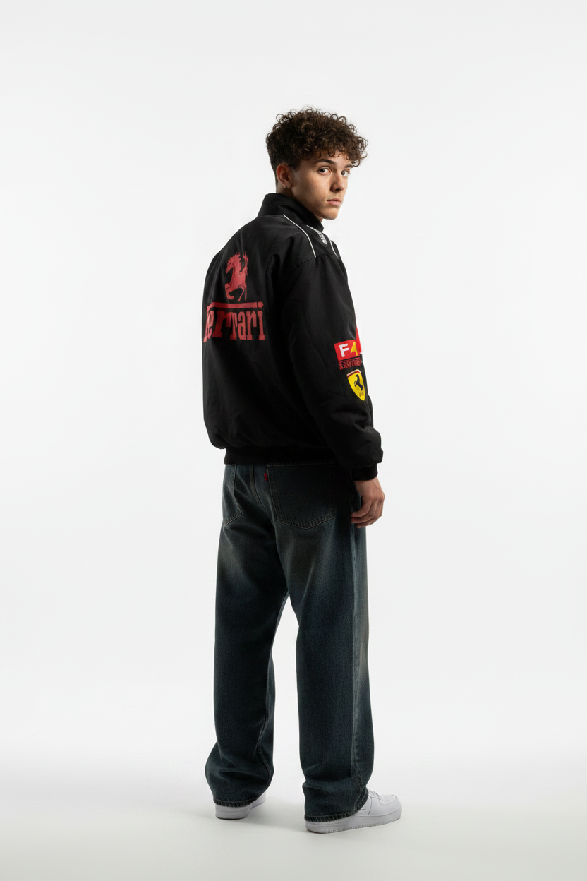 Person wearing a black Ferrari jacket on a white background